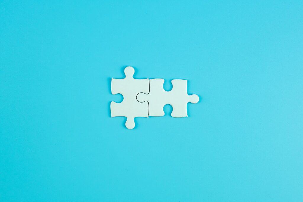 Jigsaw puzzle pieces on blue background with copy space for text. solutions, mission, successful